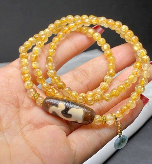 Chuỗi thạch anh tóc vàng mix dzi như ý + cham điếu ngọc hoa bay
