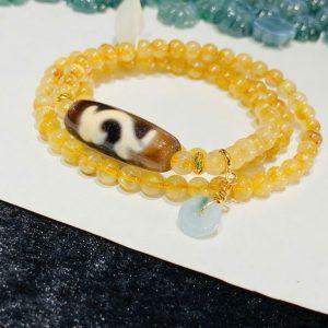 Chuỗi lắc tay Thạch anh tóc vàng mix Dzi Như Ý – Kết tinh của tài lộc, hanh thông và may mắn viên mãn