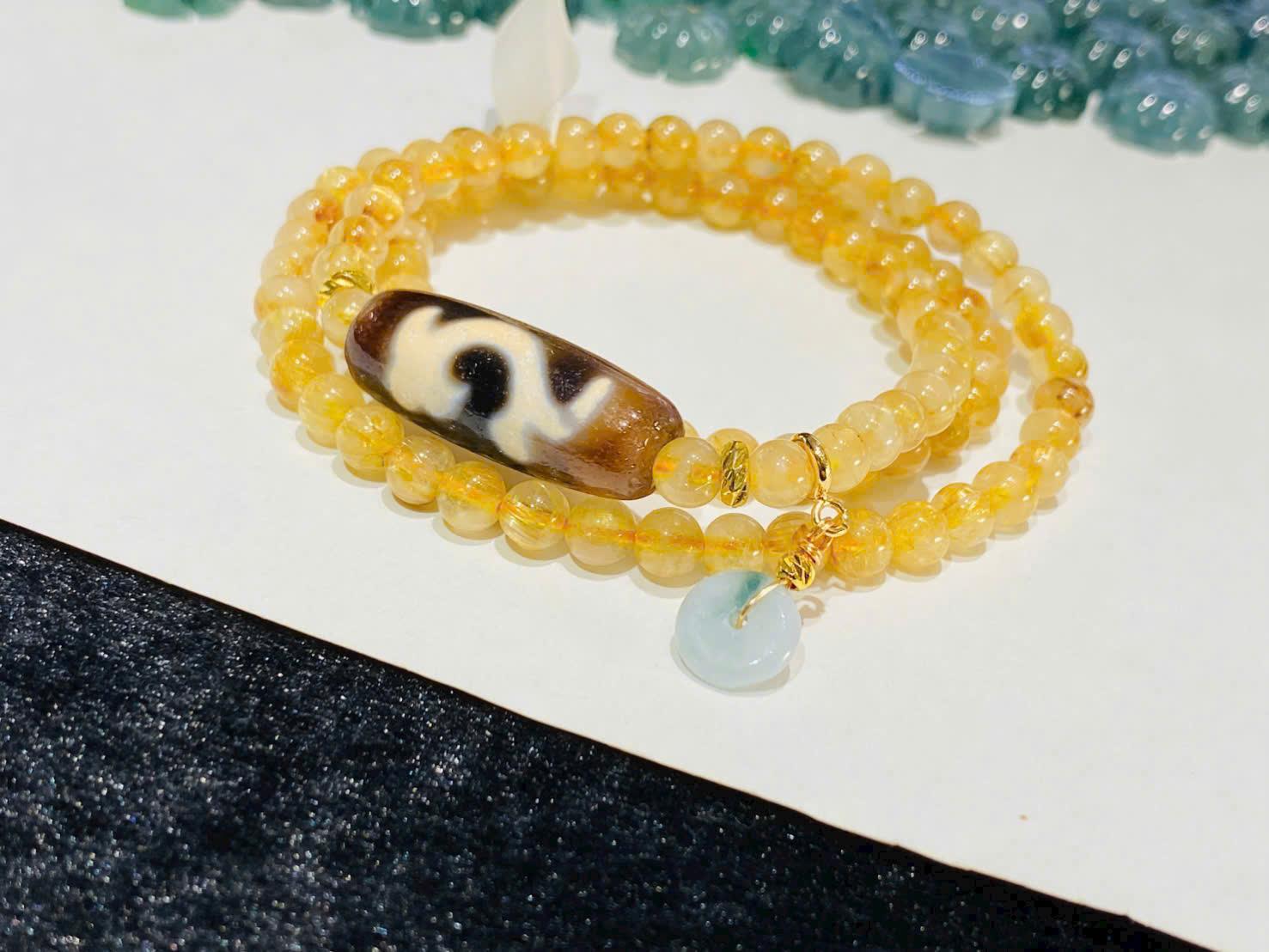 z7406163414764_aef8f77cdd94a53e0d4149960d8bbb10 Chuỗi lắc tay Thạch anh tóc vàng mix Dzi Như Ý – Kết tinh của tài lộc, hanh thông và may mắn viên mãn